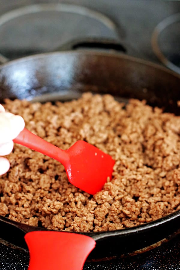 Browning ground beef in a cast iron skillet