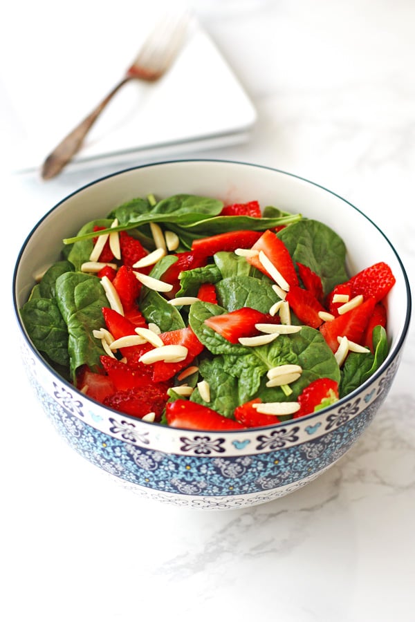 Strawberry Spinach Salad in a blue and white serving bowl