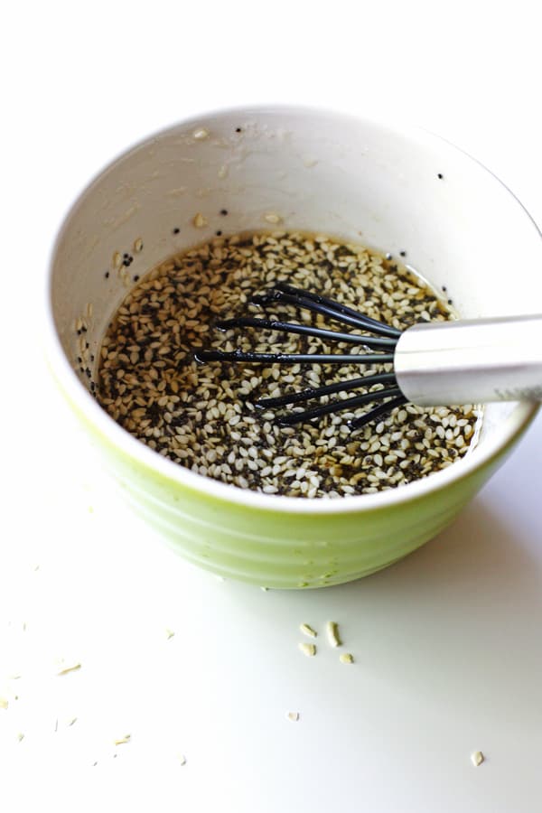 Homemade poppyseed salad dressing ingredients getting whisked in a bowl.