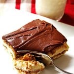 Slice of eclair cake on a plate with a glass of milk
