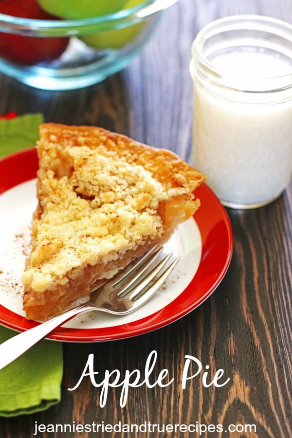 Slice of apple pie on a plate with a glass of milk.