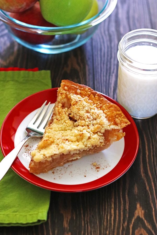 Slice of apple pie on a plate with a fork