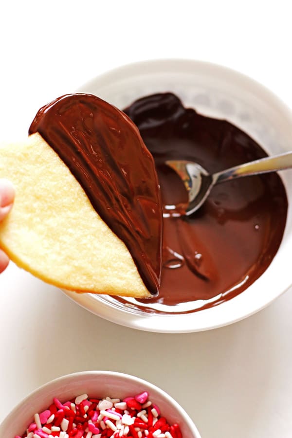 Dipping sugar cookies in melted chocolate