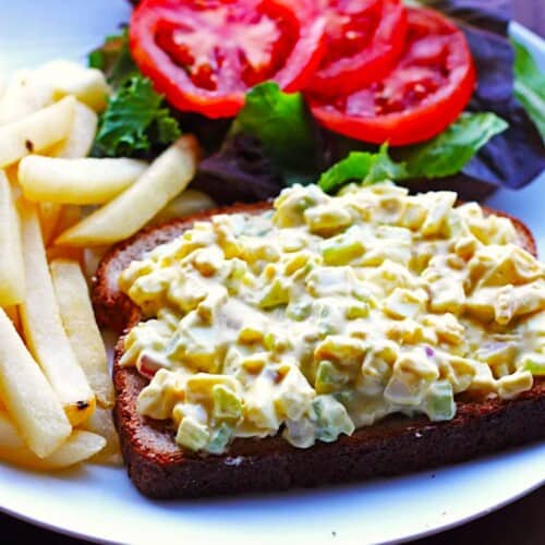 Simple to make egg salad on a piece of toast with a side of fries.