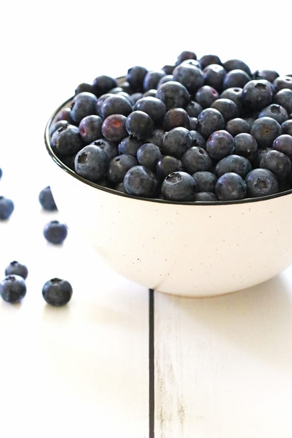 A white bowl filled with blueberries