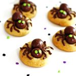 Peanut butter cookies with edible spiders on top of them