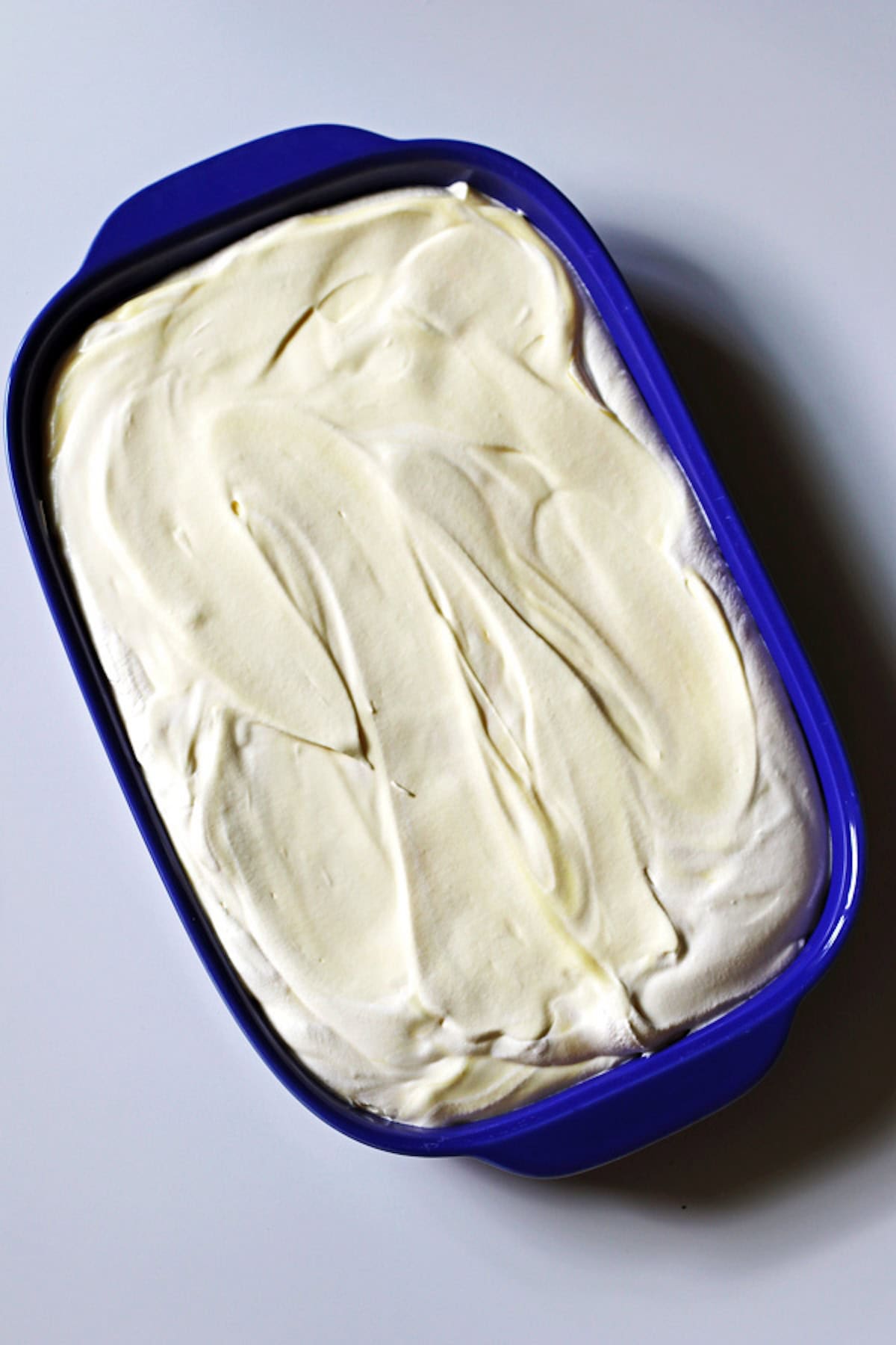 Pudding mixture spread out evenly in a baking dish