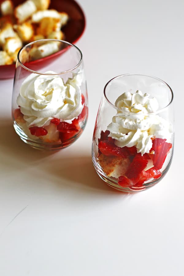 Layering toasted angel food cake, strawberries and whipped cream in glasses