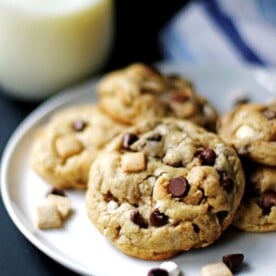 Several S'mores Cookies on a white plate with a glass of milk next to them