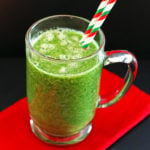 A green smoothie made with orange, banana, greens, water, & flaxseed.
