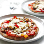 This recipe for Veggie-Pita-Pizza makes individual pizzas. They are made with whole wheat pitas and covered with peppers, onions, mushrooms and cheese.