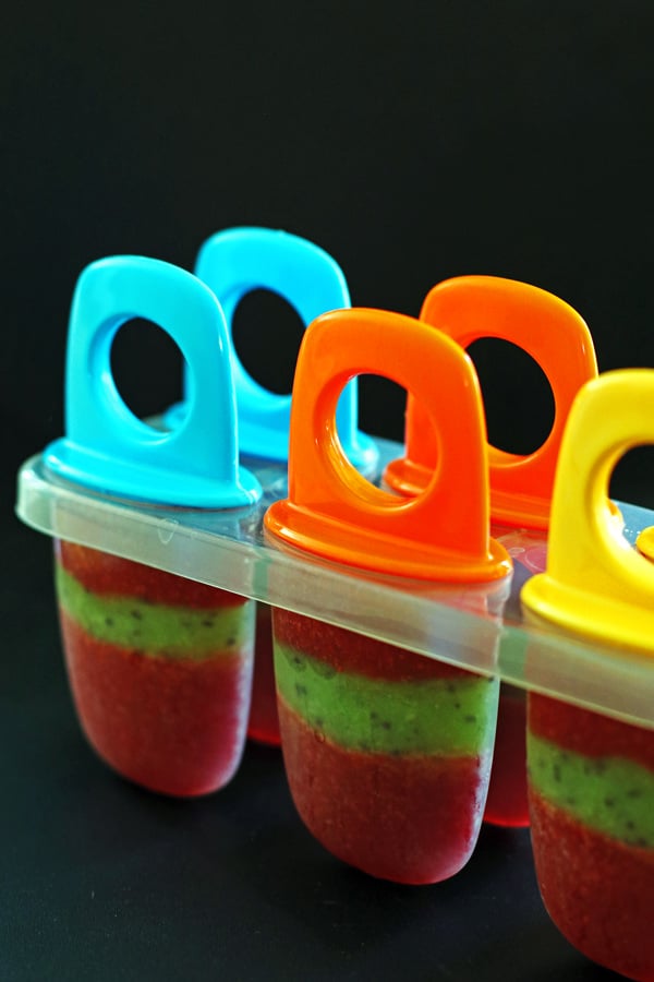 Popscile molds filled with strawberry, kiwi and strawberry puree