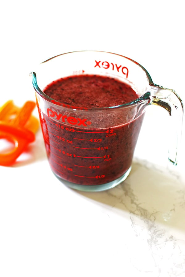 Popsicle mixture in a clear pyrex measuring cup.