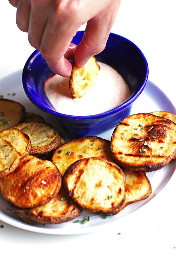 Dipping Blue Cheese Grilled Potatoes in blue cheese dip