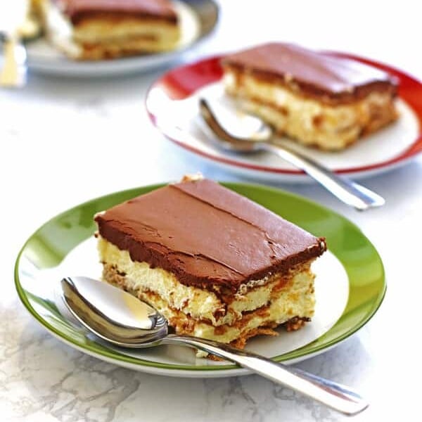 Slices of Eclair Cake on green, red and blue plates