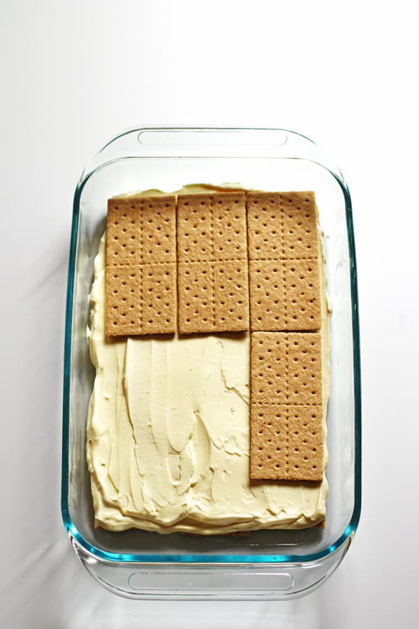 Graham crackers placed over vanilla pudding mixture in baking dish