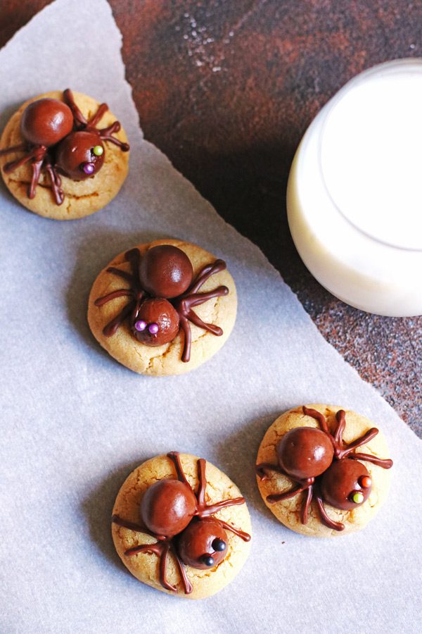 Peanut Butter Spider Cookies with milk in a glass
