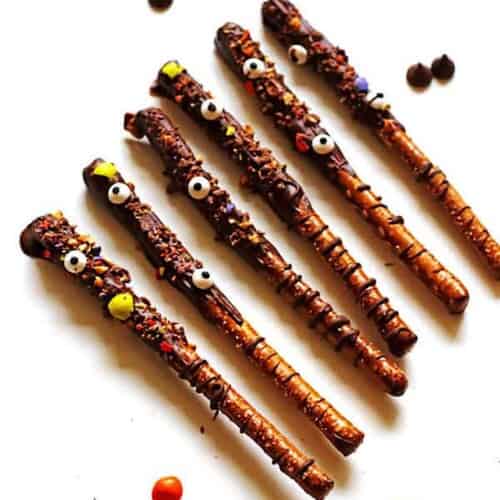 Pretzel Rods that were dipped in melted chocolate and crushed up candy and edible eyes added to them.