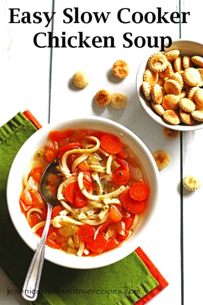 A white bowl of chicken soup with a spoon