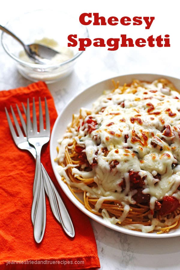 Spaghetti noodles covered with sauce and melted mozzarella cheese