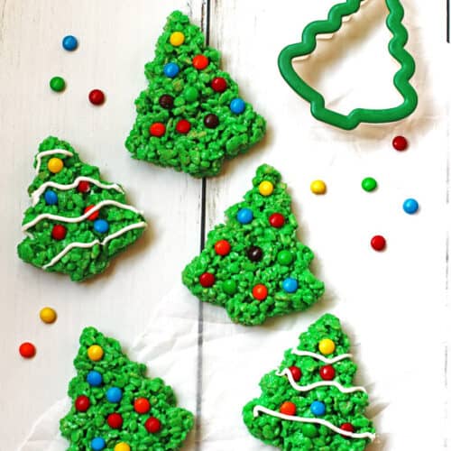 Green Rice Krispie Trees decorated with M&M candy and white icing.