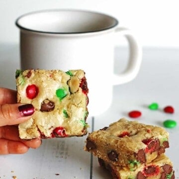 Cookie Bars on table next to a white mug