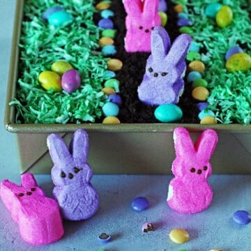 Dirt Cake decorated with bunny Peeps, candy eggs and coconut colored green for grass