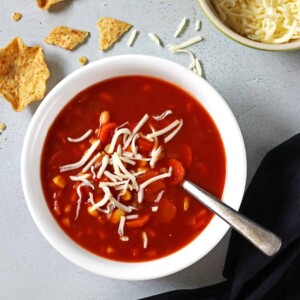 Vegetable Soup in a white bowl with a spoon in it