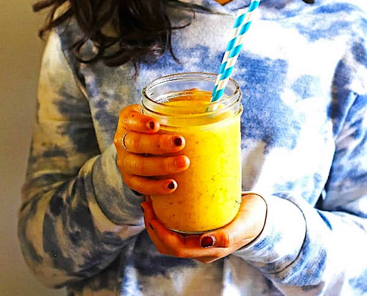 Girl holding smoothie in a canning jar