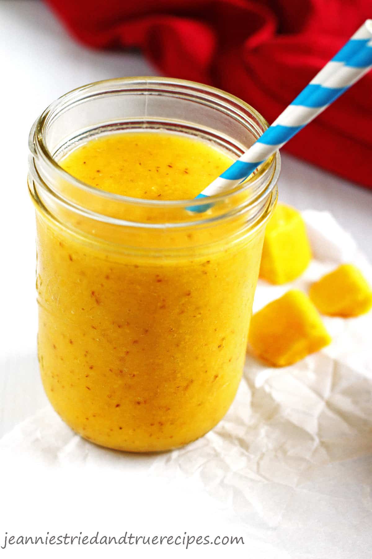 Pineapple and Mango Smoothie in a canning jar with a straw