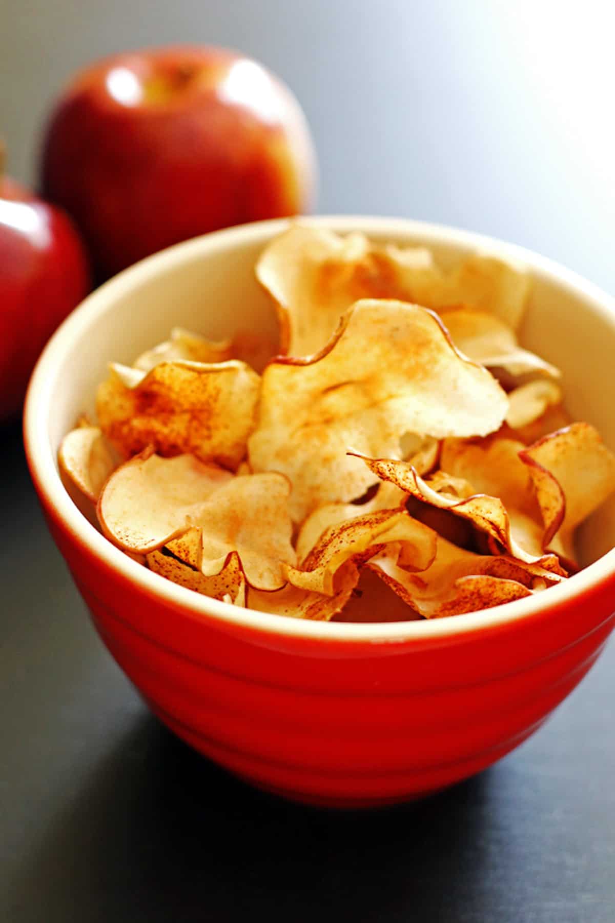 A bowl of baked apple chips.