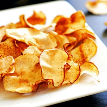 A plate of crispy cinnamon apple chips.
