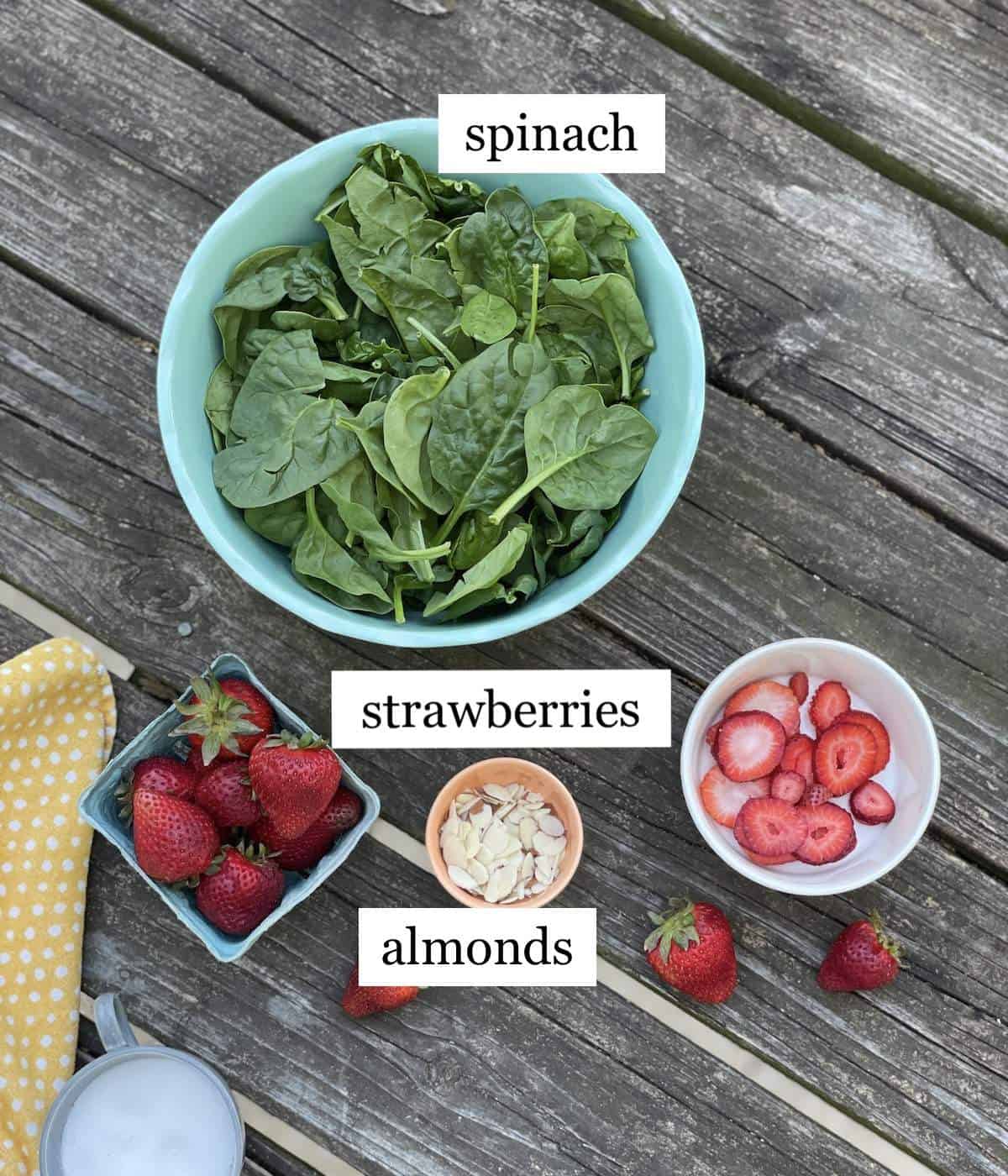 The ingredients in strawberry spinach salad, laid out and labeled.