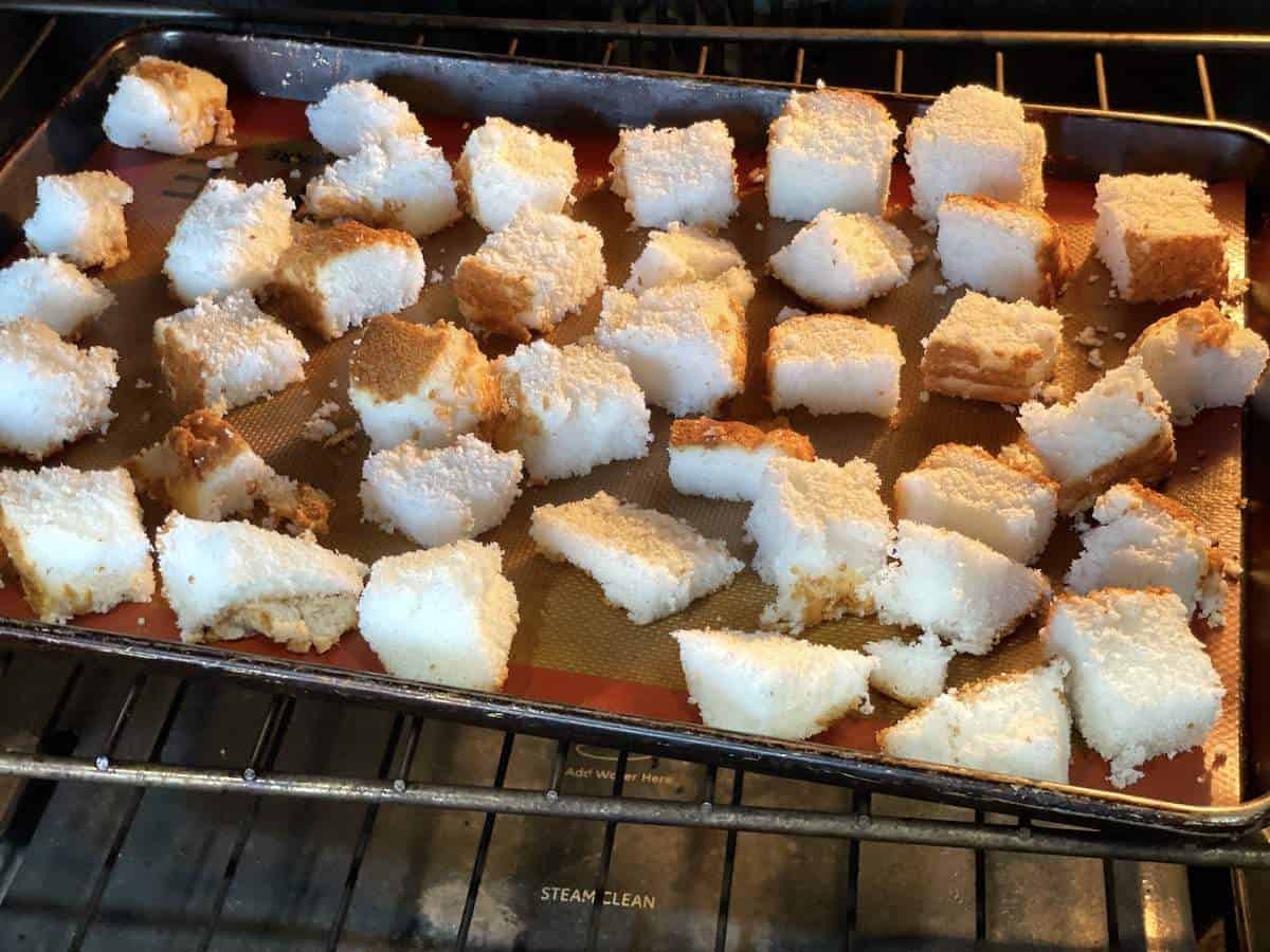 Angel food cake cubes toasting in the oven.