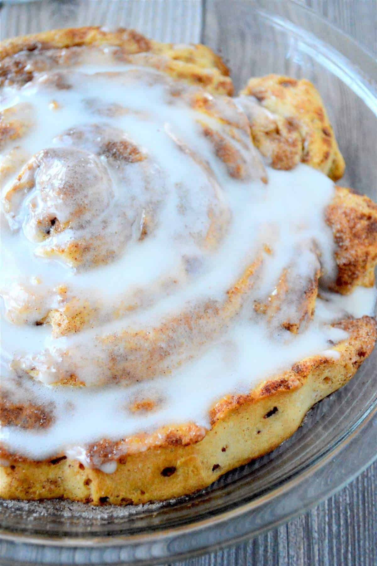 A giant fluffy cinnamon roll covered in cream cheese icing.