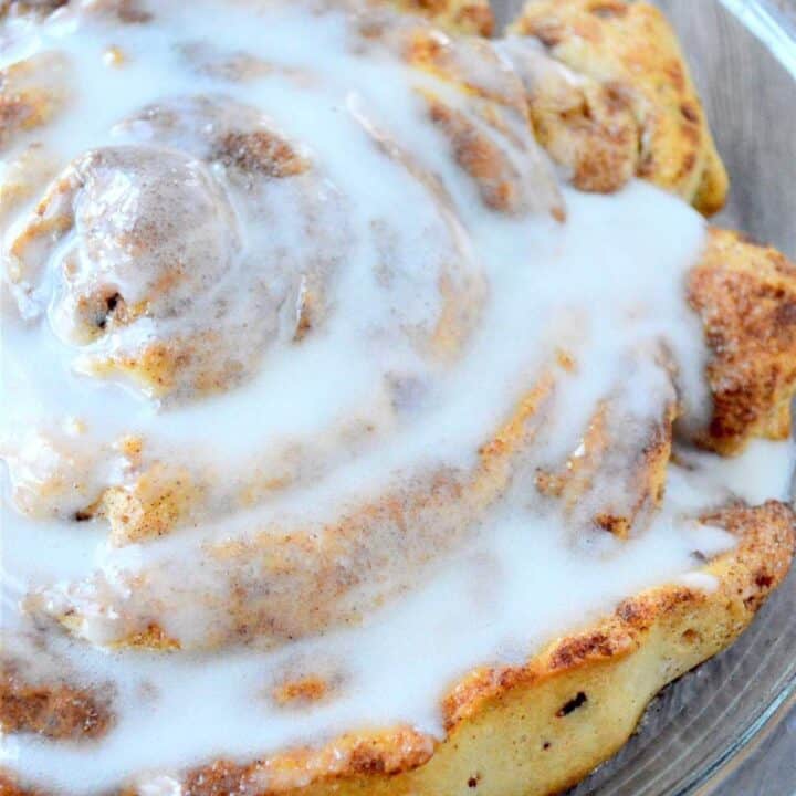 A giant fluffy cinnamon roll covered in cream cheese icing.