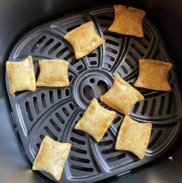Cooked pizza bites in the basket of a Gourmia Air Fryer.