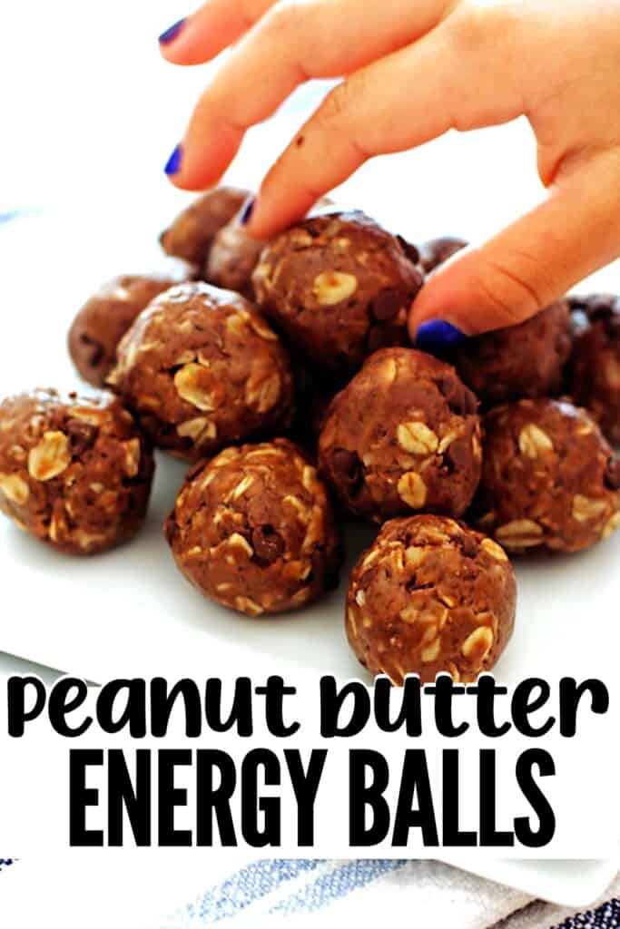 A pin image of no bake peanut butter energy balls on a white plate being picked up by a hand.