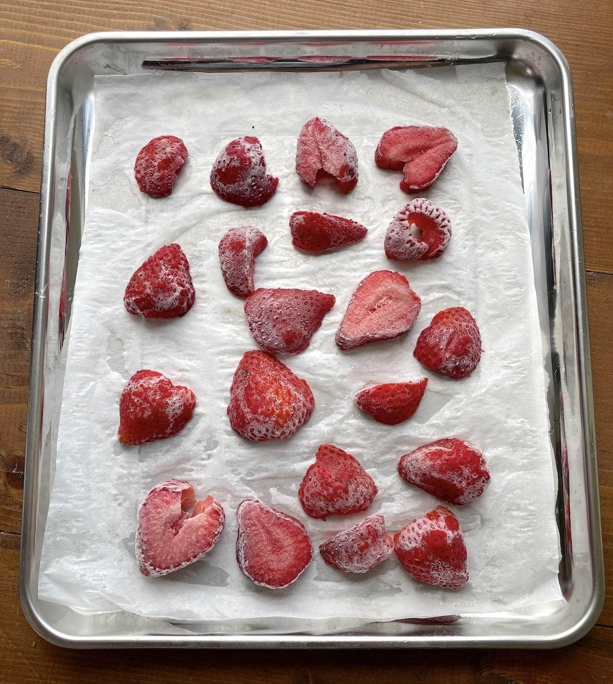 Thinly sliced strawberries ready to be frozen for jam and smoothies.