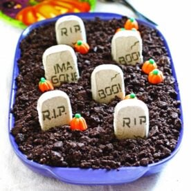 Halloween dirt cake - vanilla pudding covered with crushed up Oreo cookies covered with pumpkin and tombstone edible decorations.