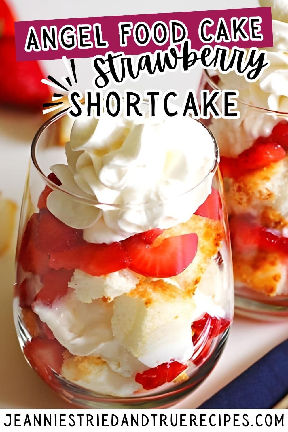 A pin image of strawberry shortcake angel food cake in wine glasses with whipped cream on top.
