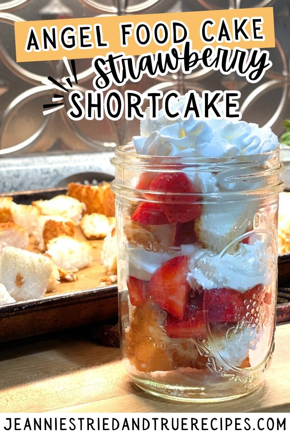 A pin image of strawberry shortcake angel food cake in a mason jar with whipped cream on top and toasted cake in the background.