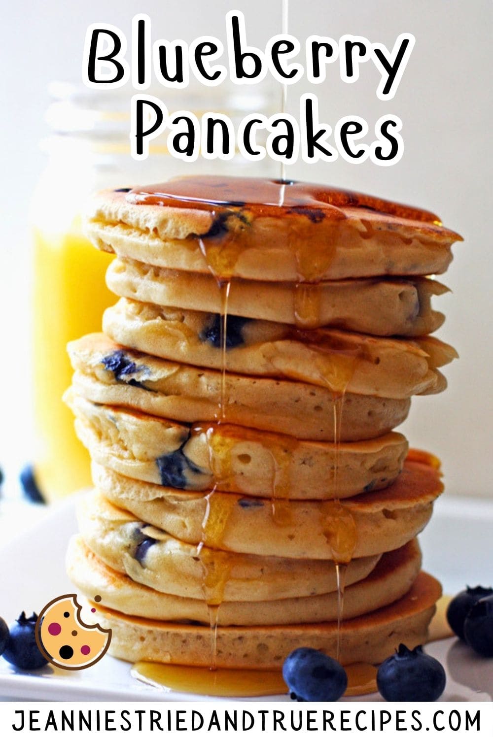 A pin image of a stack of fluffy blueberry pancakes with maple syrup dripping down the side.