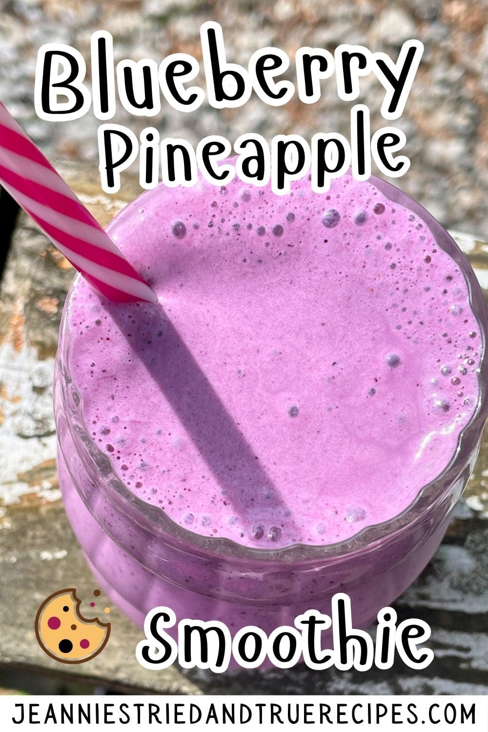 A pin image of a blueberry pineapple and banana smoothie with a pink and white striped straw.